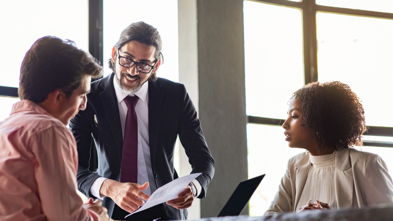 Leader discussing an innovative idea with an employee and assigning the right team member to execute it