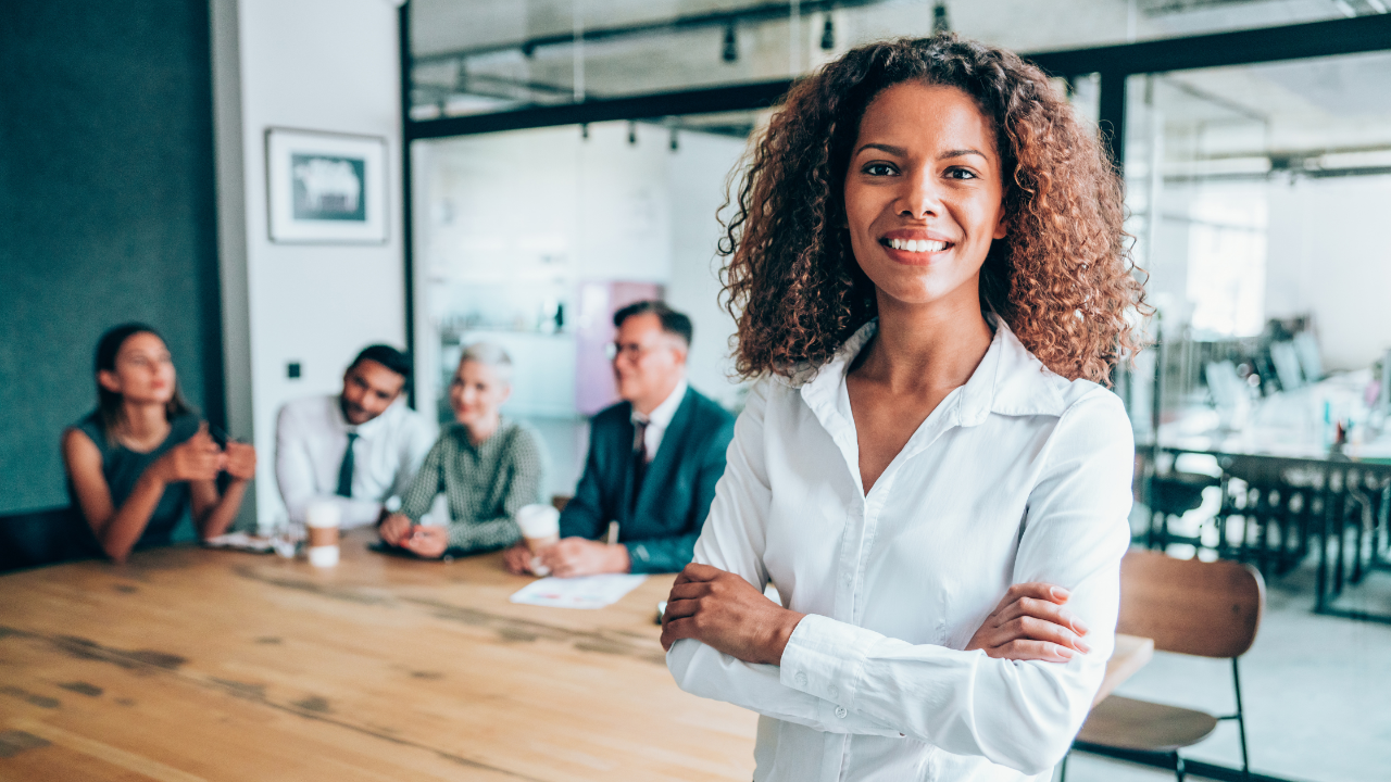 A strong leader with a loyal team behind her during a challenging workplace discussion