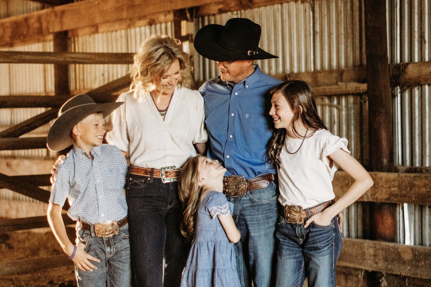 Calli and CJ Thorne with their three children in the barn