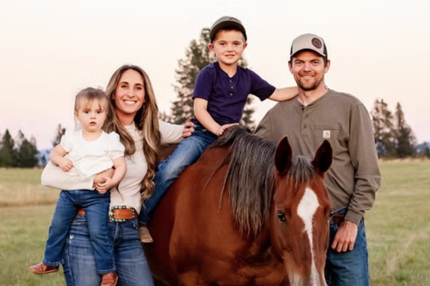 Sammy Jo and Kyle Kristiansen of KrisCo Farms with their two children and a horse