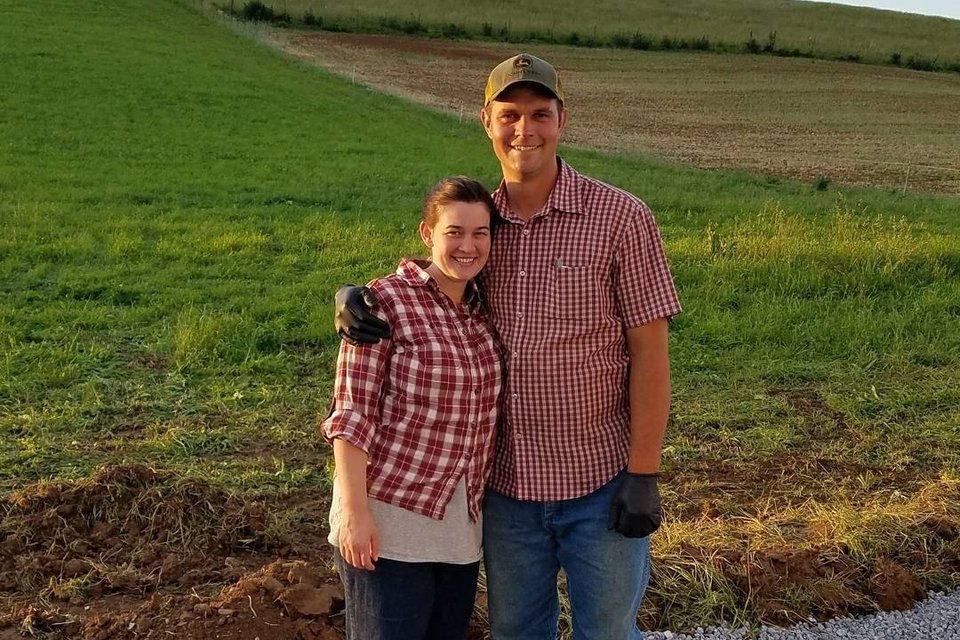 Kristen and Ben Beichler at the edge of their pasture at Creambrook Farm