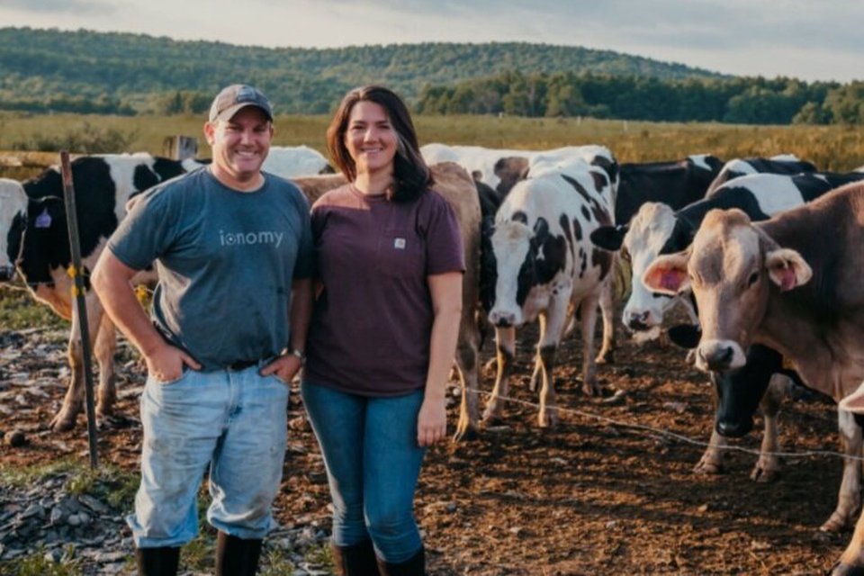 Jess and Jeremy Hoffman with the dairy herd at Sunset View Creamery