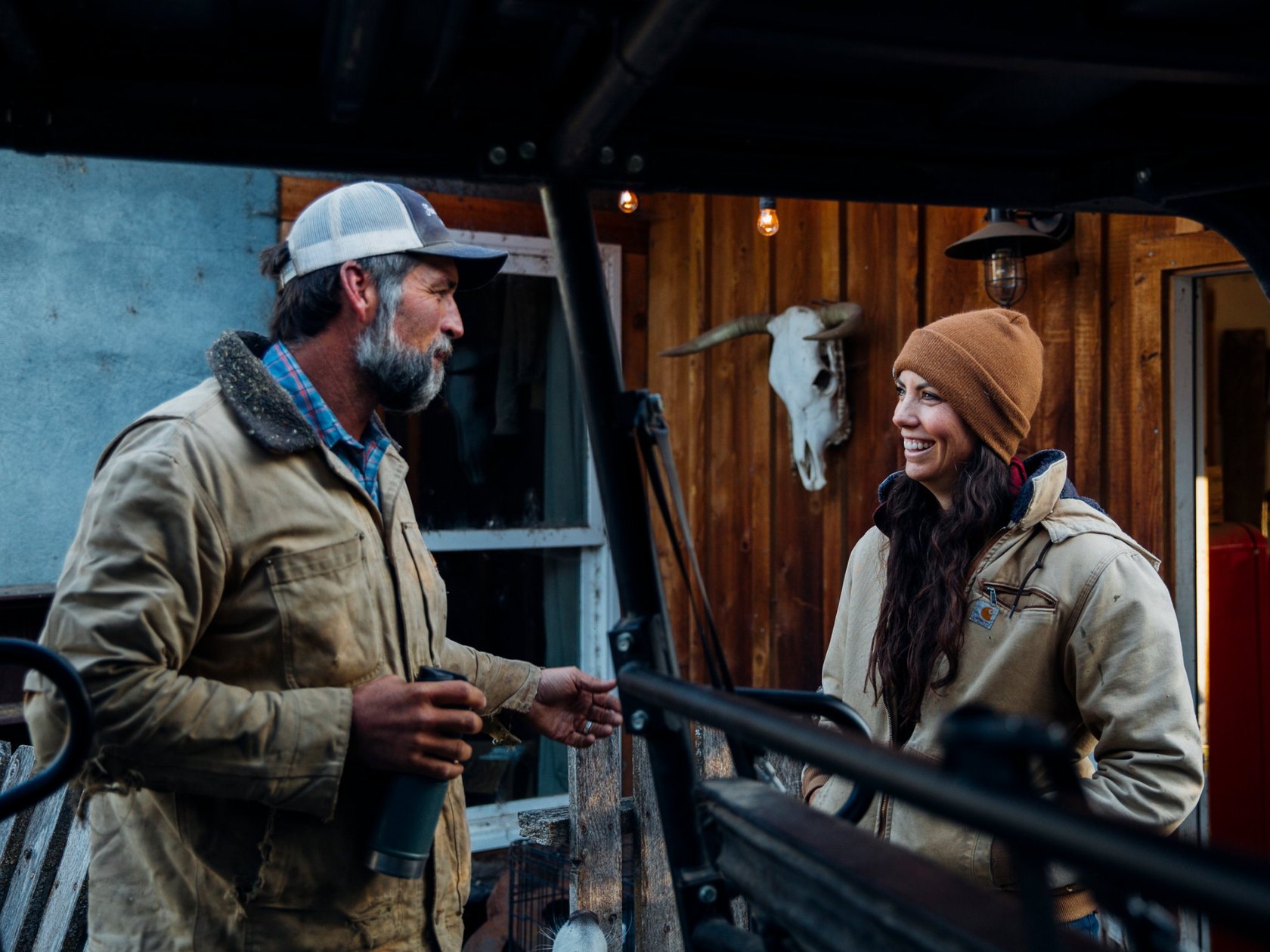Mary and Brian Heffernan talking outside in their work jackets at Five Marys Ranch