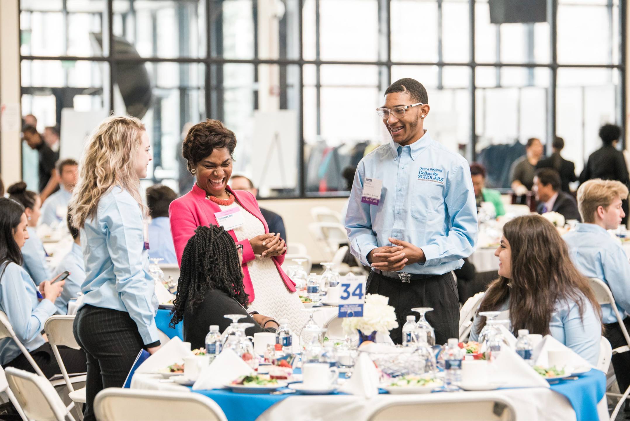 Jacqueline Baker laughing with students at a luncheon