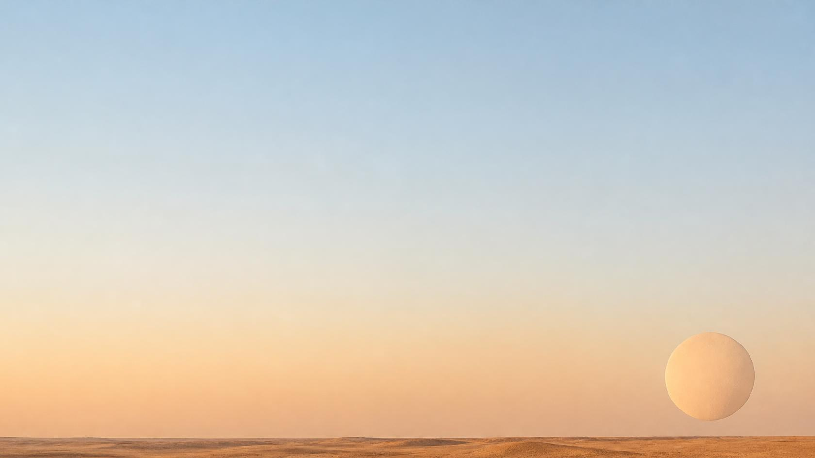 A clear sky fading from pale blue to peach over the desert, with a pale clay sun low on the right.
