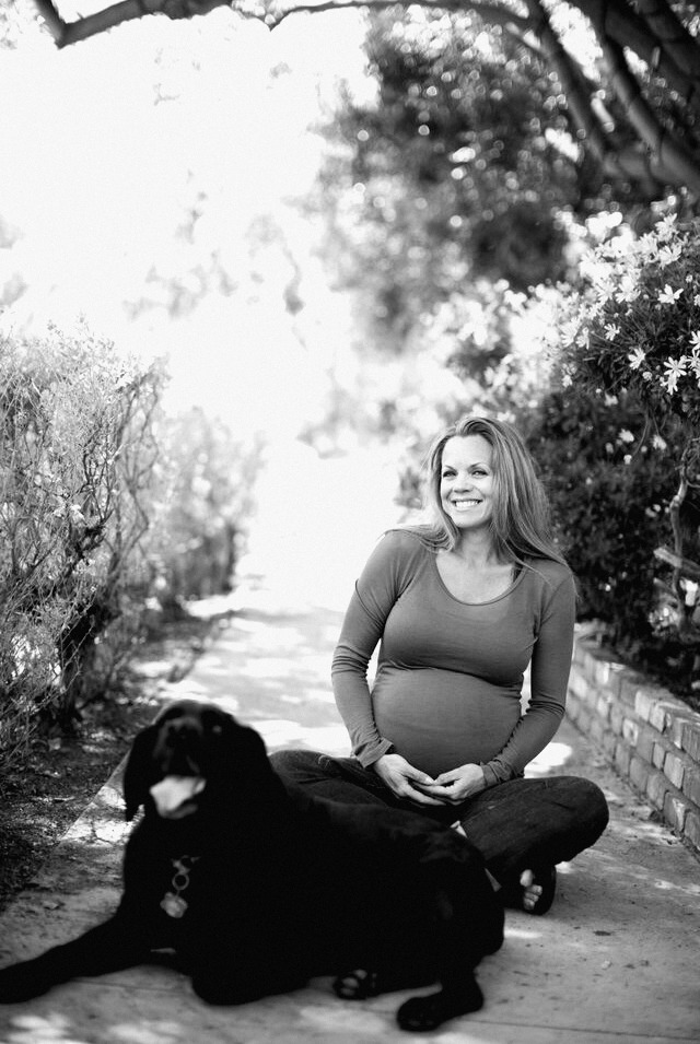 Alicia pregnant at 38, smiling, with her dog