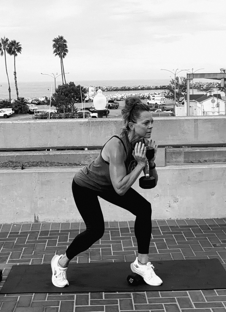 Alicia doing a goblet side lunge with a dumbbell