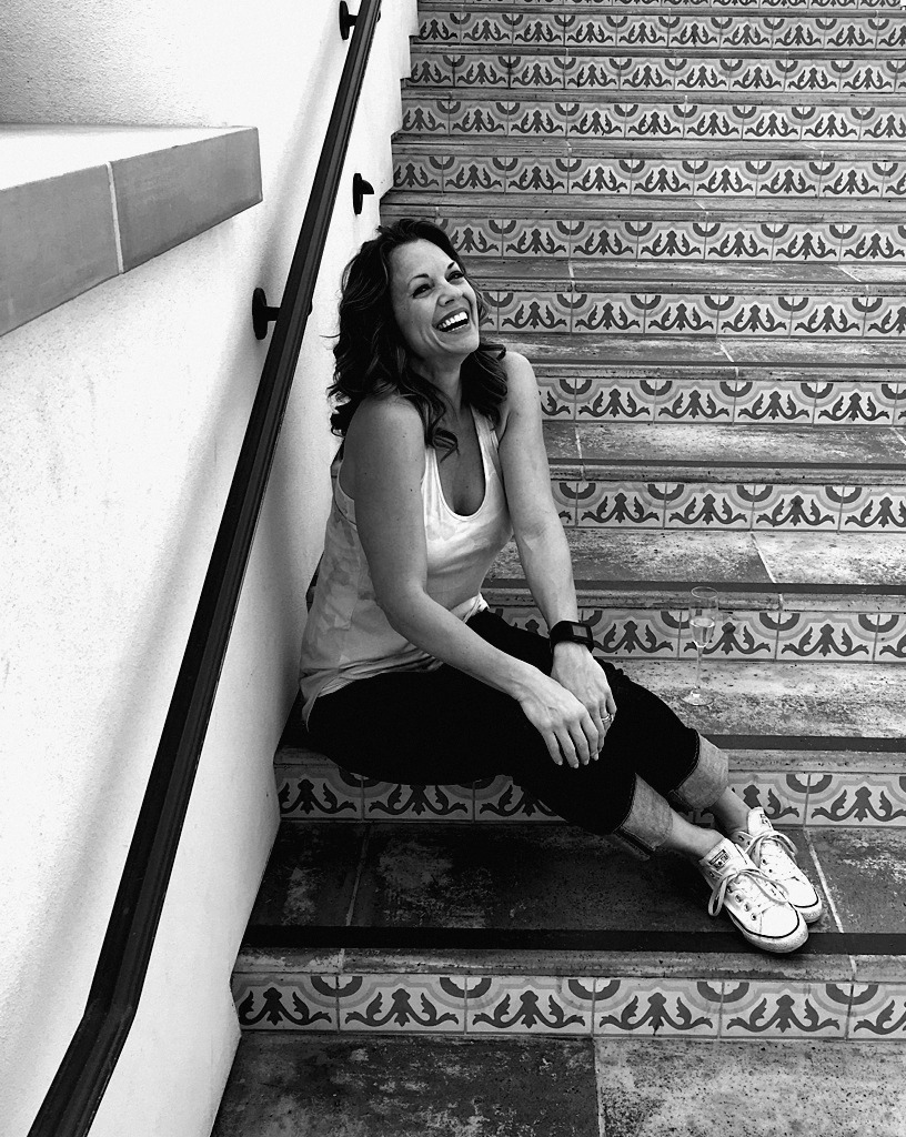 Alicia laughing on a tiled staircase