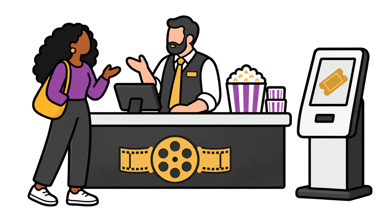 A moviegoer chatting with the theater manager at the ticket counter while a self-serve ticket kiosk stands unused.