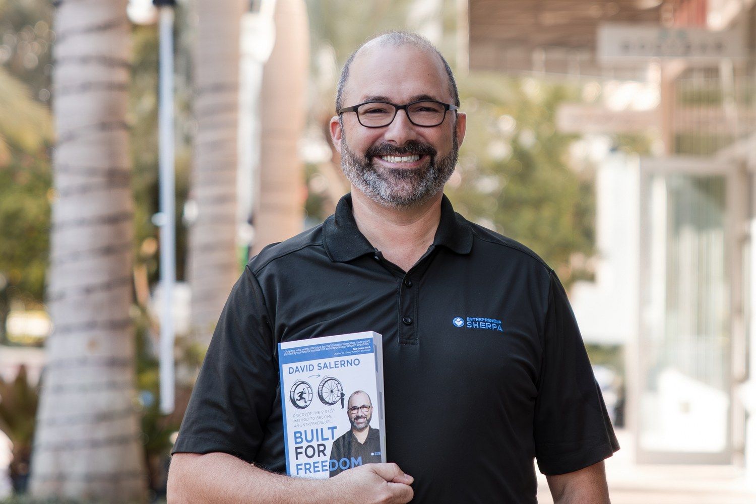 David Salerno, the Entrepreneur Sherpa, holding his book Built for Freedom