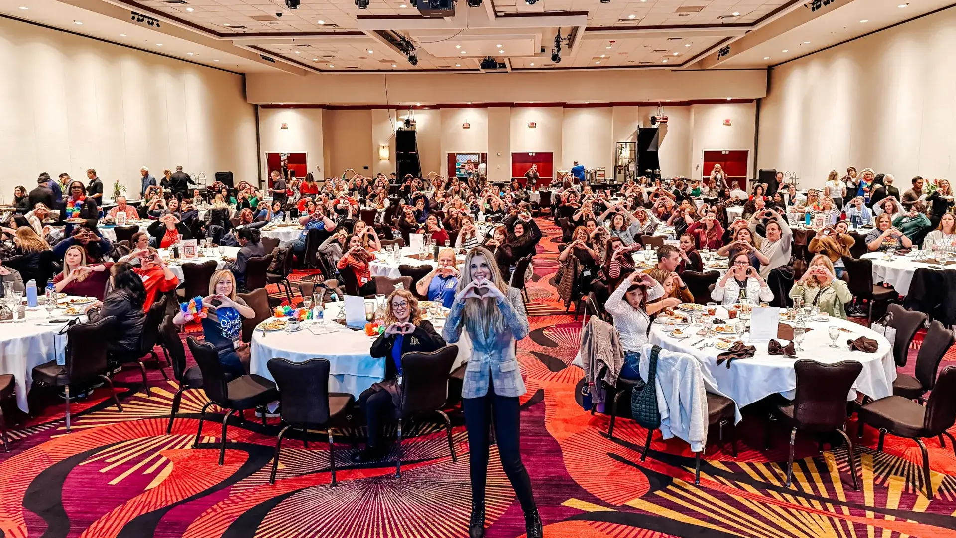 Lyndsay presenting on stage at a keynote
