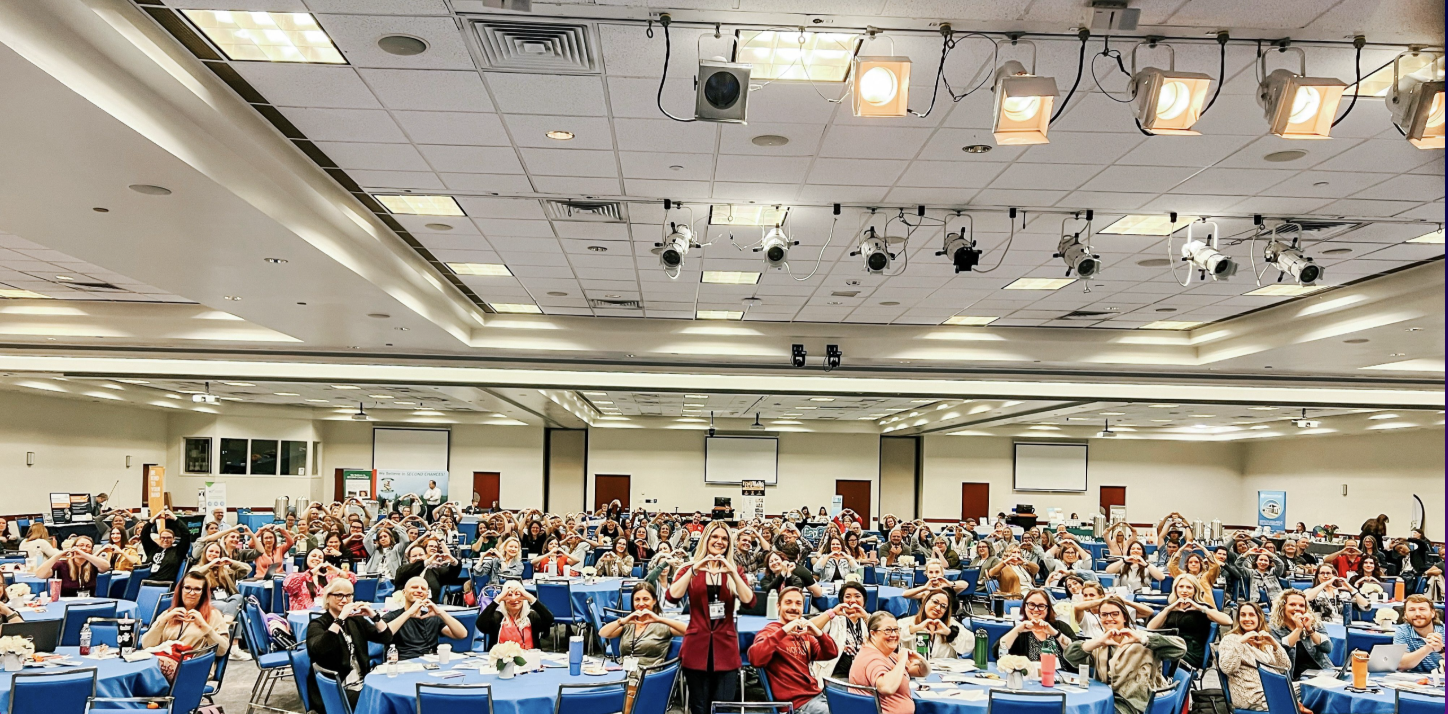 Idaho school counselors making heart hands with Lyndsay