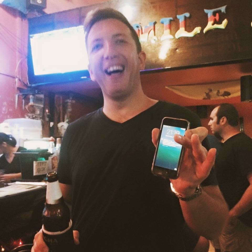 Simon Vernon celebrating his first sale in a bar in Thailand