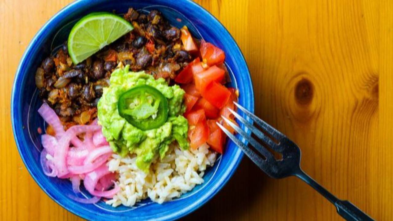 fajita bowl with brown rice, beans, avocado, bell peppers and tomatoes
