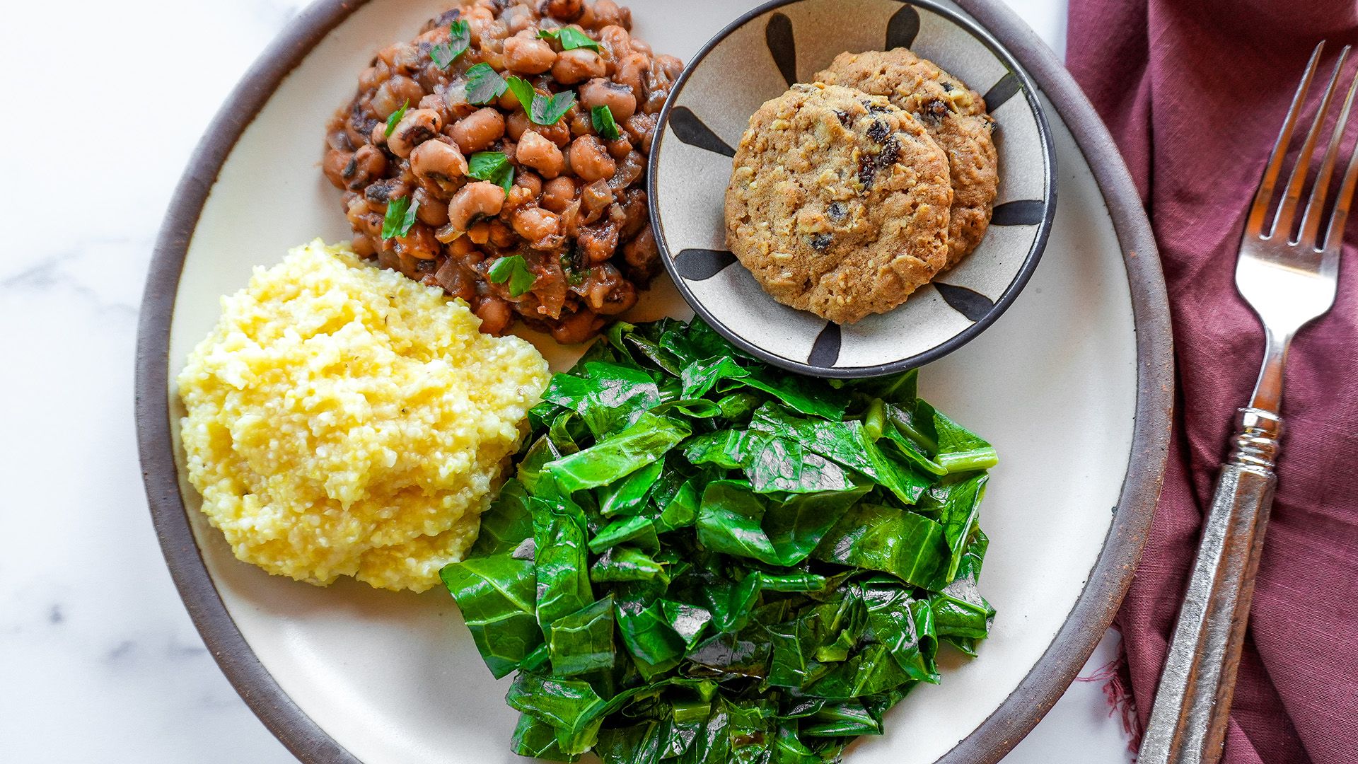 Southern black-eyed peas served with sautéed collard greens, whole-grain cornmeal, and oatmeal raisin cookies.