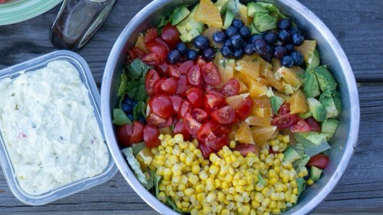summer salad with romaine, corn, tomatoes, avocado, blueberries, oranges