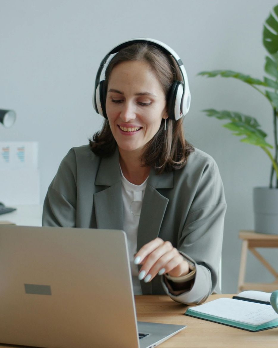 General transcription student working from home with headphones and a laptop