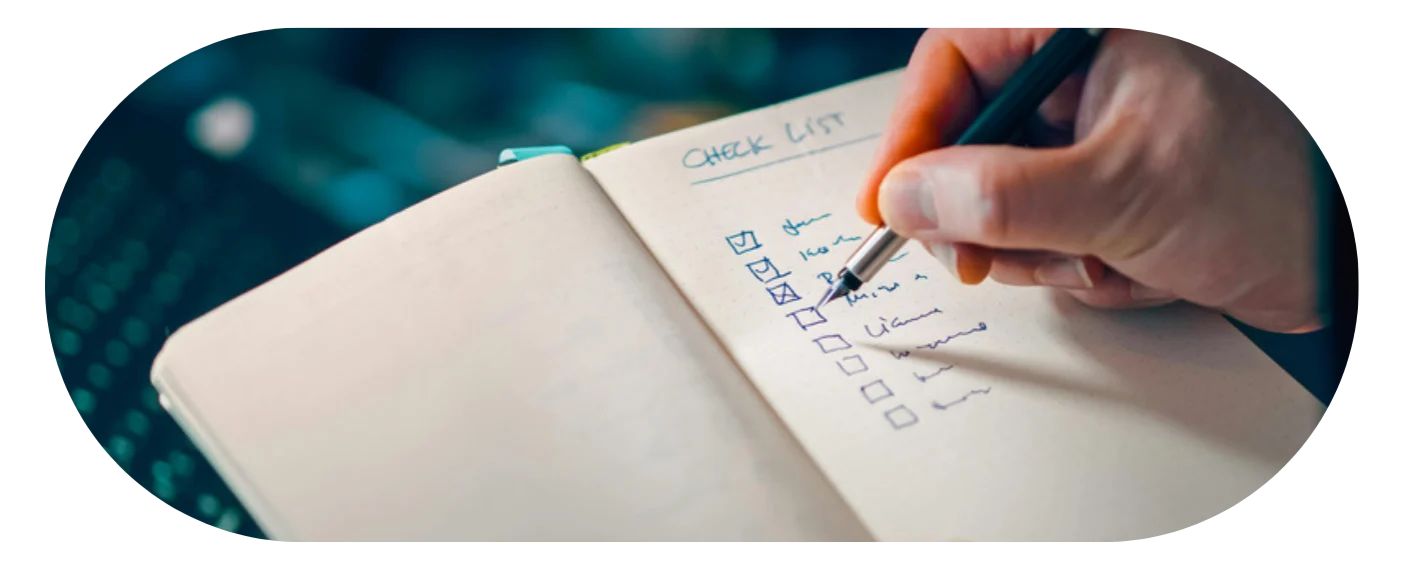 Hand writing a checklist in a notebook