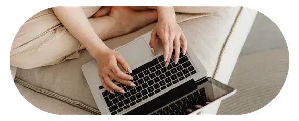 Person typing on a laptop with focused expression