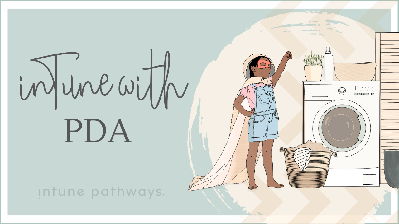 Illustrated course cover in a soft, muted pastel palette. The text reads “inTune with PDA” in dark charcoal grey, with “intune pathways.” in very light grey-green underneath. The background is mostly pale sage green/blue with cream and beige brush-stroke shapes.  On the right, a child dressed as a superhero stands confidently with one fist raised, wearing a coral-pink eye mask, soft pink shirt, pale blue denim overalls, and a light peachy-cream cape. She has warm brown skin and dark brown hair. Beside her is a laundry-room scene with an off-white washing machine, a woven beige-and-tan laundry basket, a pale cream basket, a bottle, and a small plant with muted green leaves.