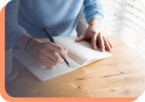 Woman writing in a notebook (placeholder)