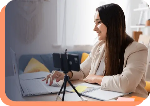Woman smiling while looking at laptop (placeholder)