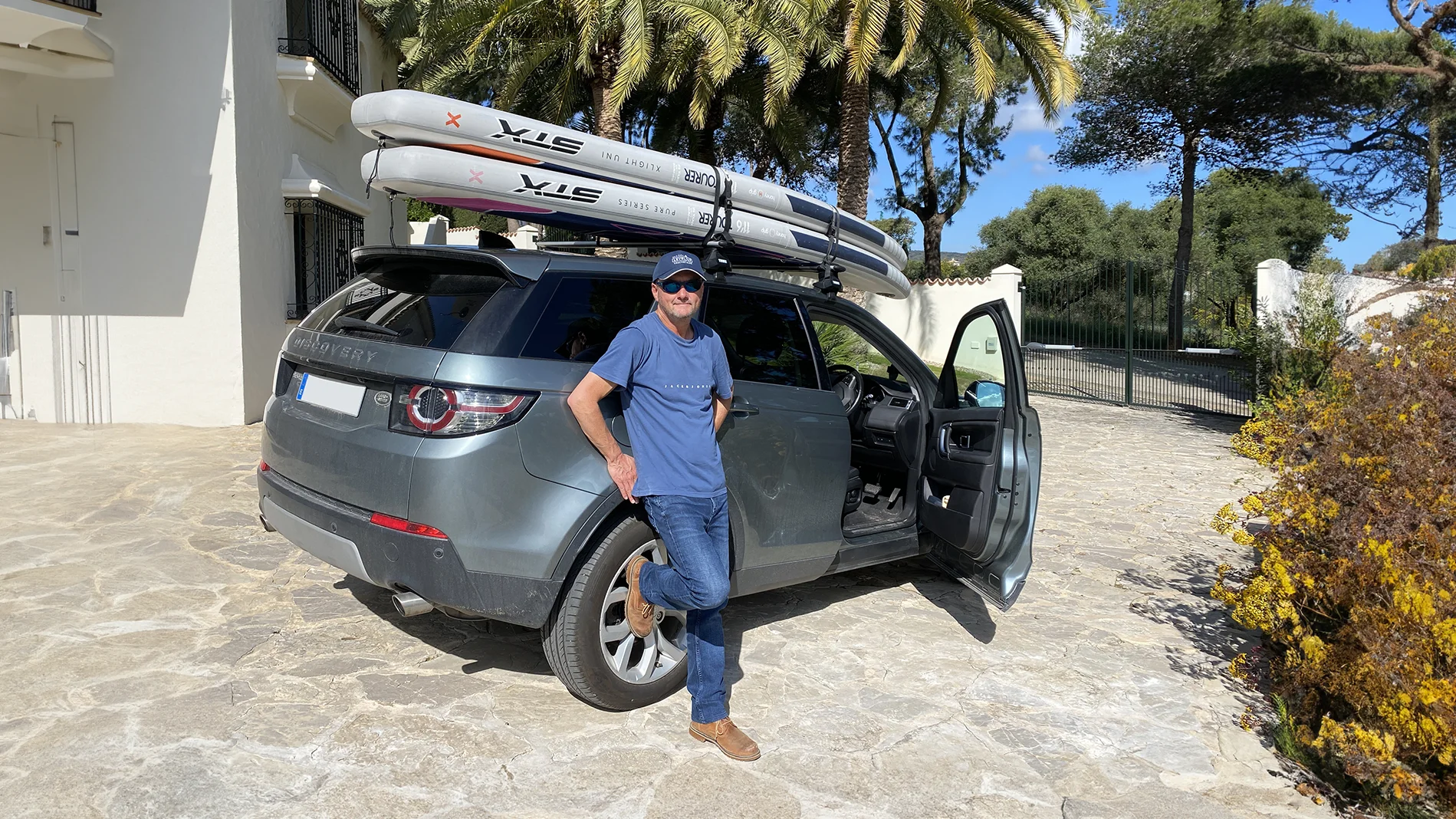 Andy Brown, Kajabi Expert with his LandRover and Paddle Boards