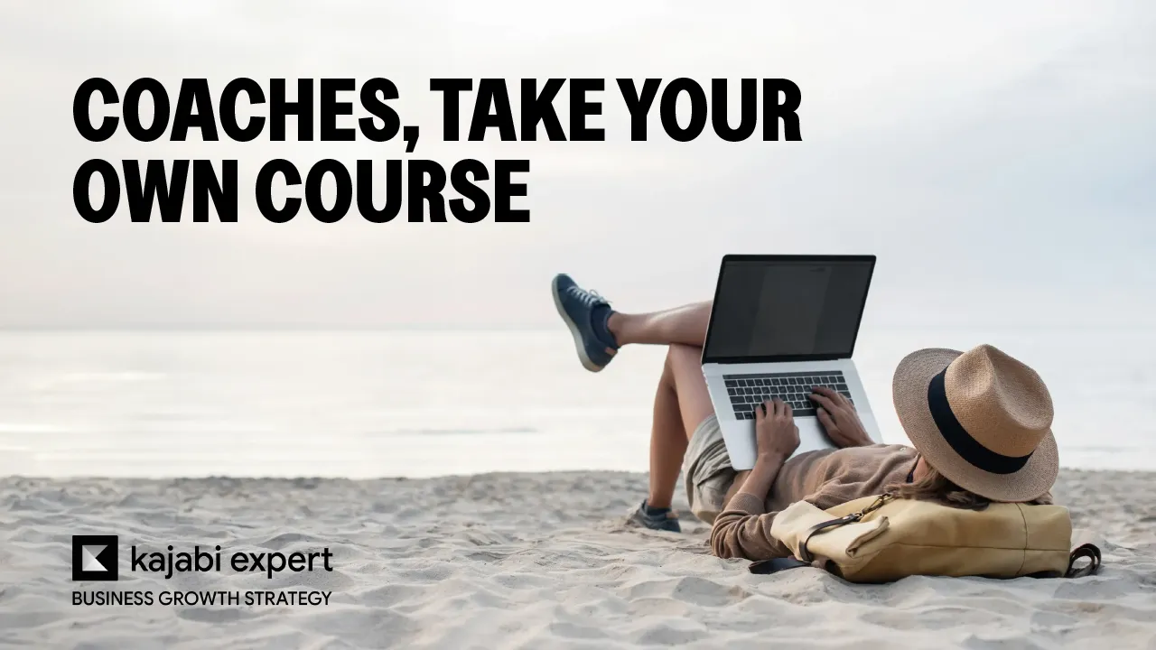 Coach lying on a sandy beach with a straw hat, working on a laptop to review their own online course.