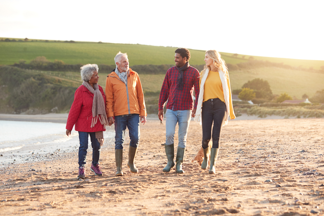 Multigenerational family walking together on the beach