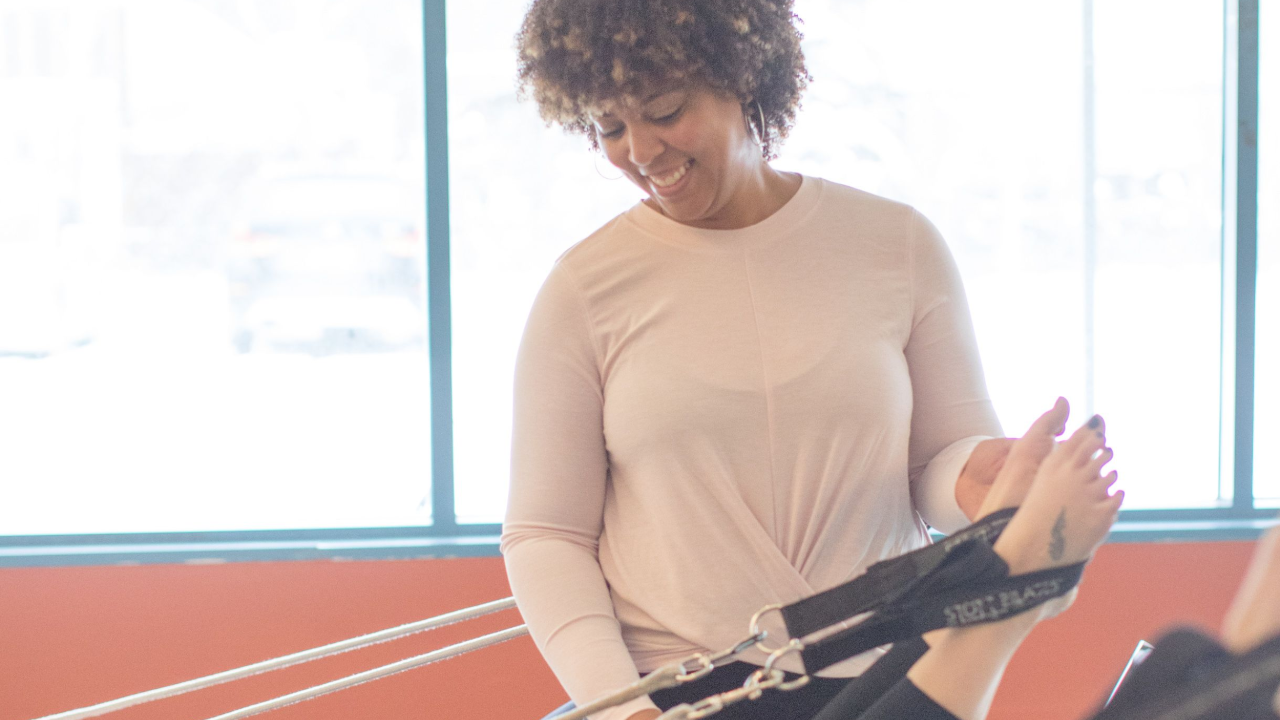 Instructor cueing joint neutral at the midfoot during a VASIE® Pilates foot exercise