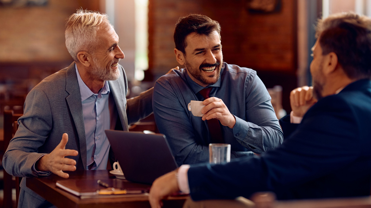 Businessmen having a friendly conversation over coffee in a casual meeting