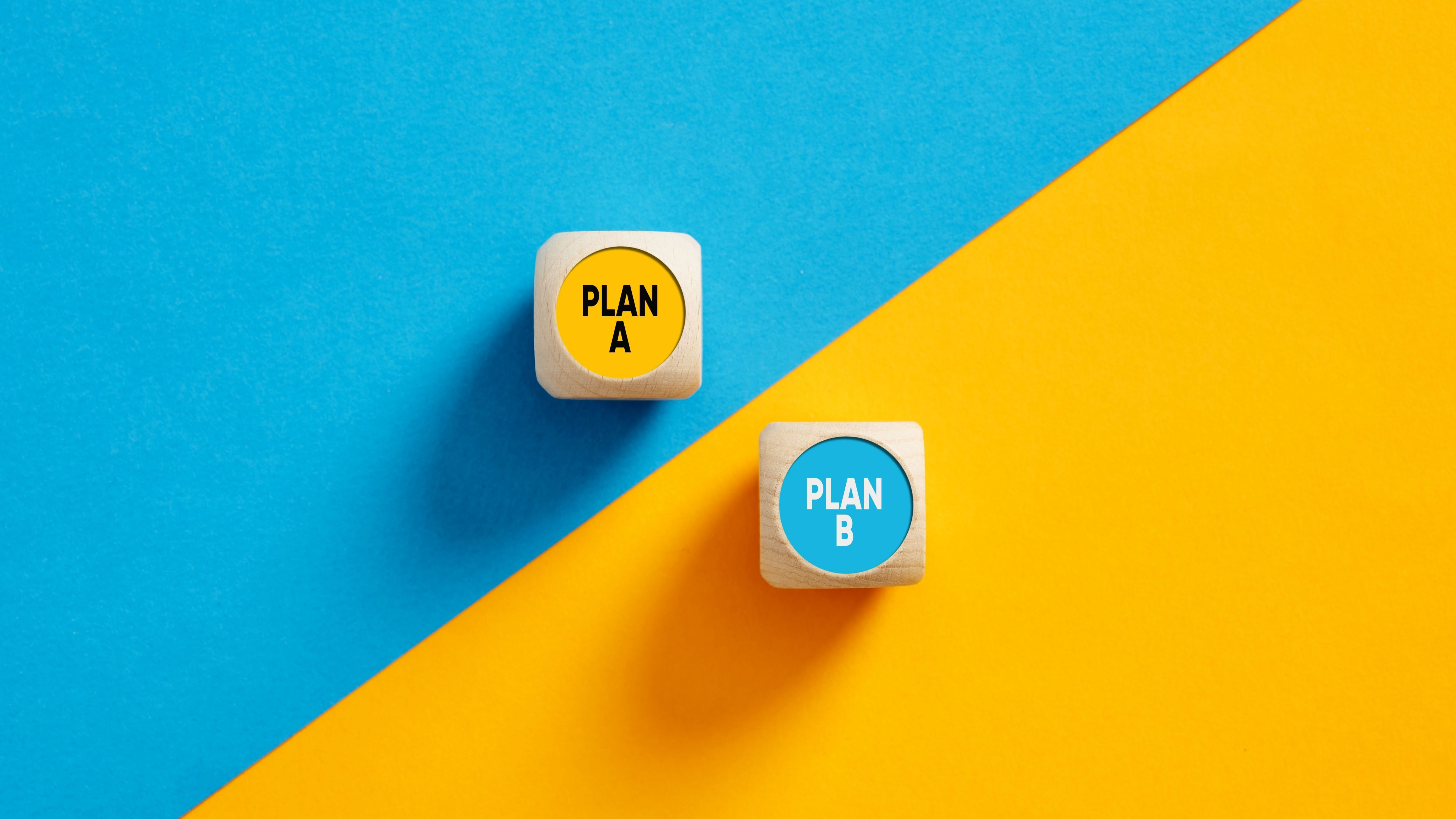 The words Plan A and Plan B on wooden cube push buttons