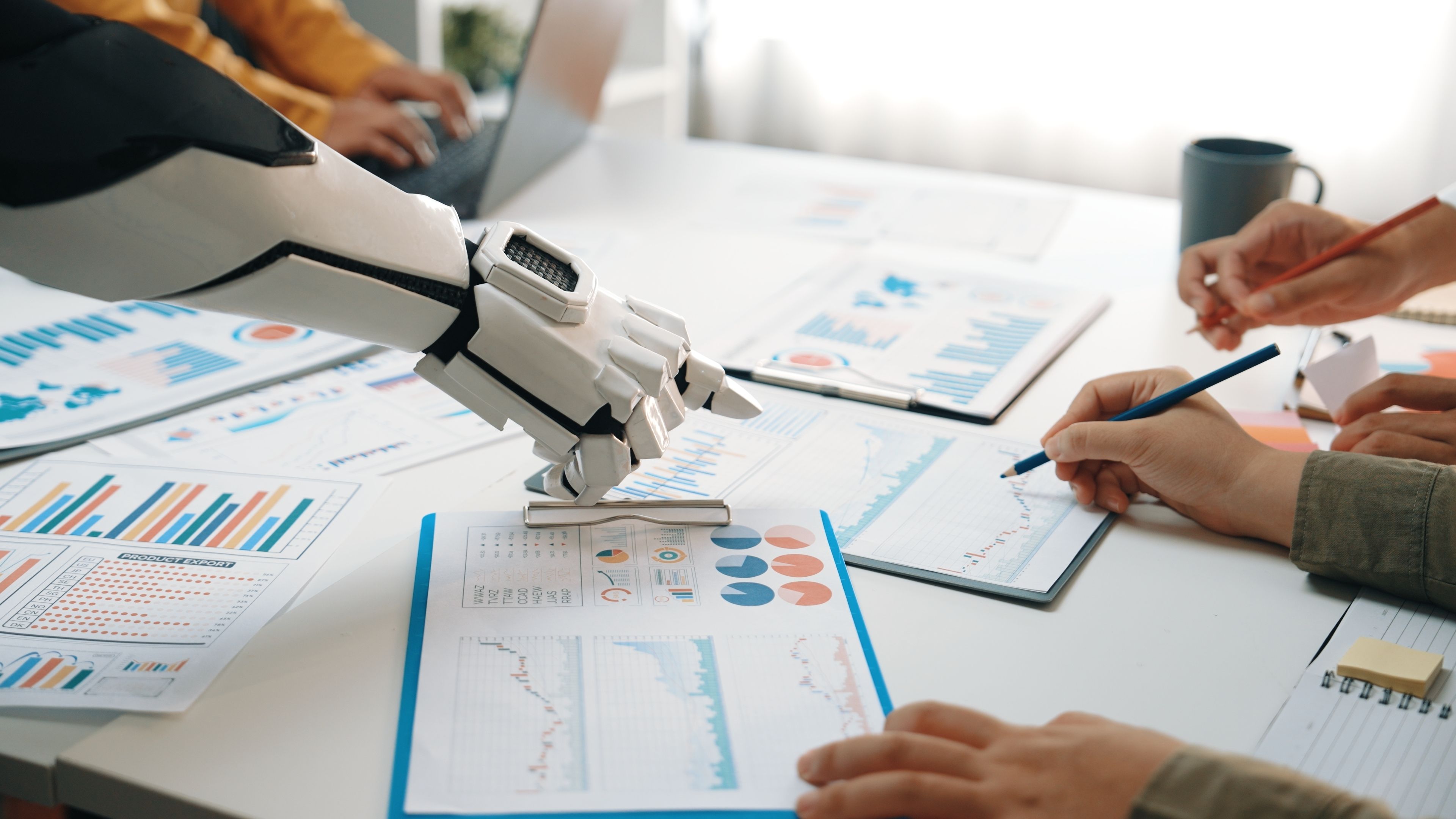 A robotic hand assists human participants in a business meeting