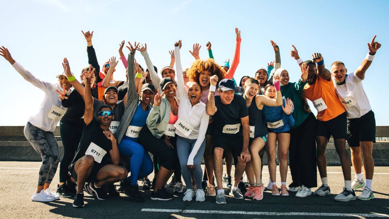 A group of enthusiastic runners celebrate together 
