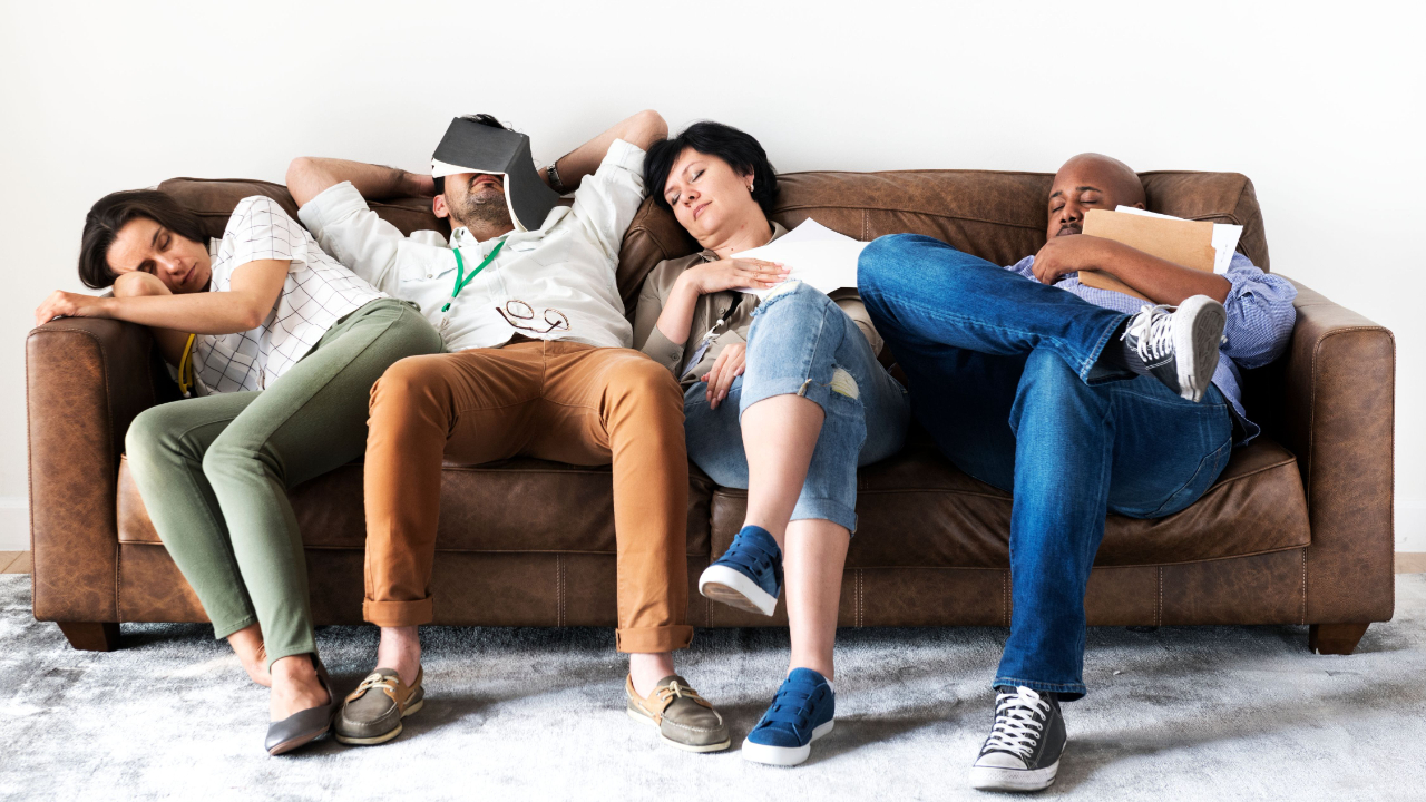 Diverse workers taking rest on couch