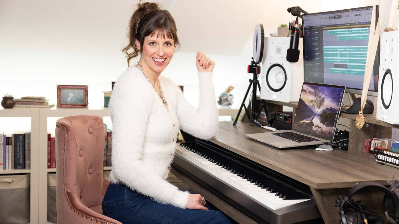 Cheryl B. Engelhardt laughing at the keyboard in her studio