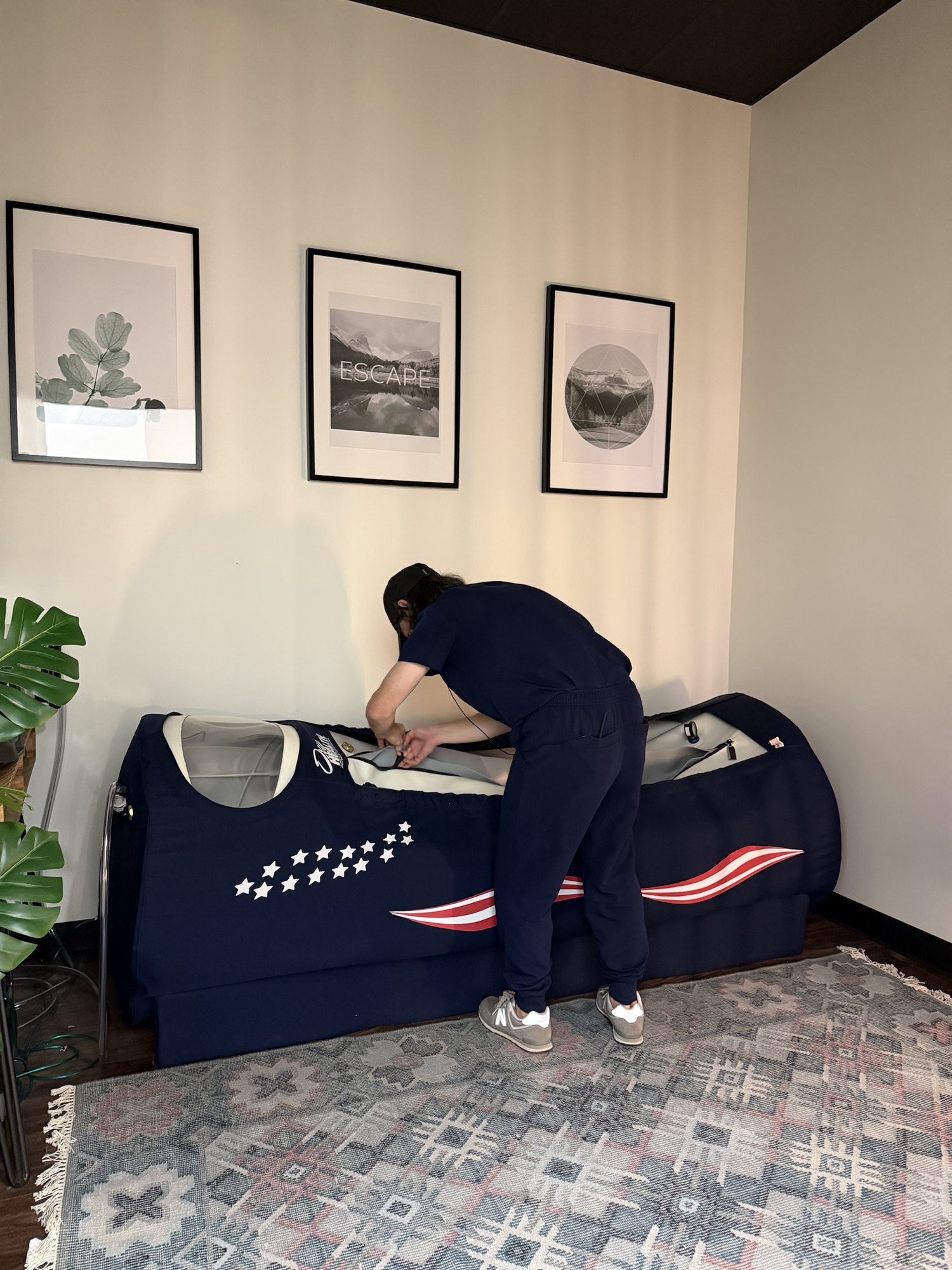 A team member getting the OxyHealth Vitaeris 320 hyperbaric chamber ready at HBOT Chattanooga