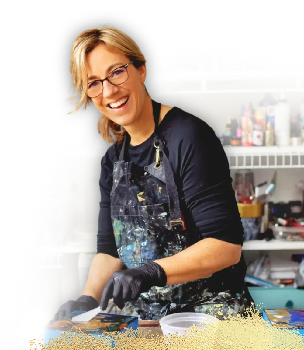mixed media art teacher holding paint brushes