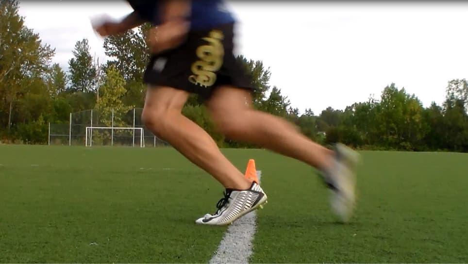 athlete runs around cones