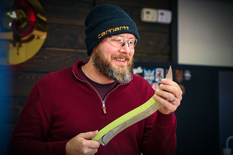 Kyle Royer holding a knife in progress during the build process