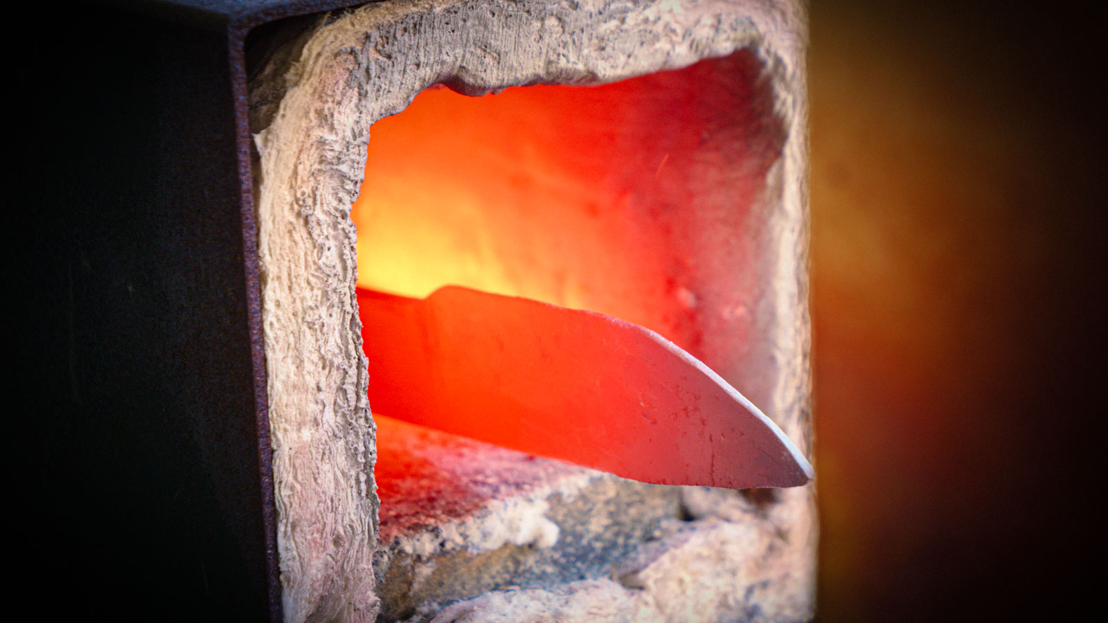 Glowing steel blade in the forge during Kyle Royer's hunting knife build