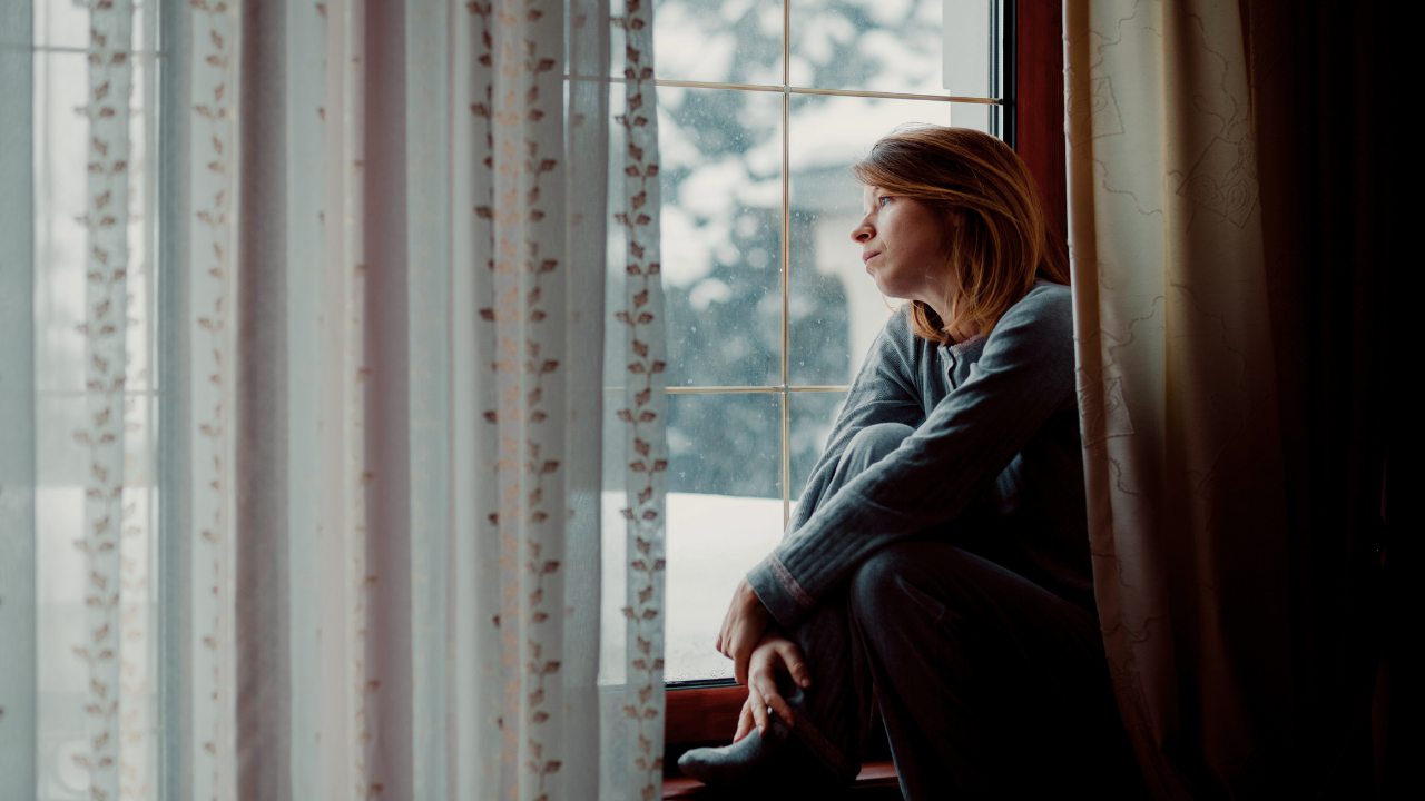 A  woman stares out the window. 