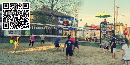 Man hitting a ball outside Mac's Pizza Pub