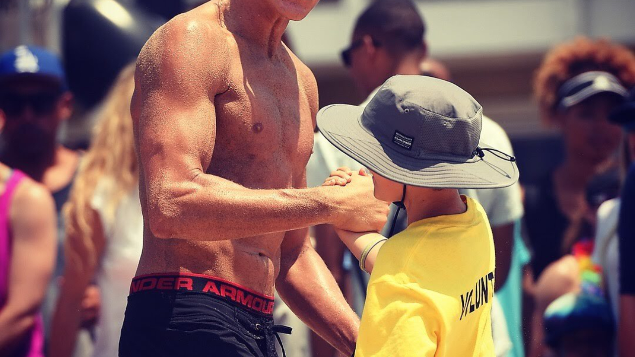 Coach Mark Burik working one-on-one with a junior beach volleyball player on the sand