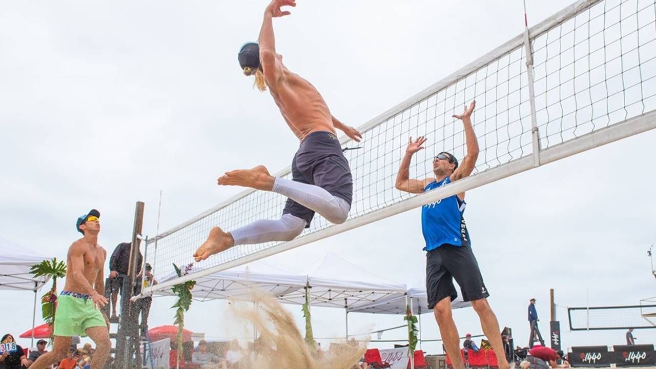 image of beach volleyball hitting over net