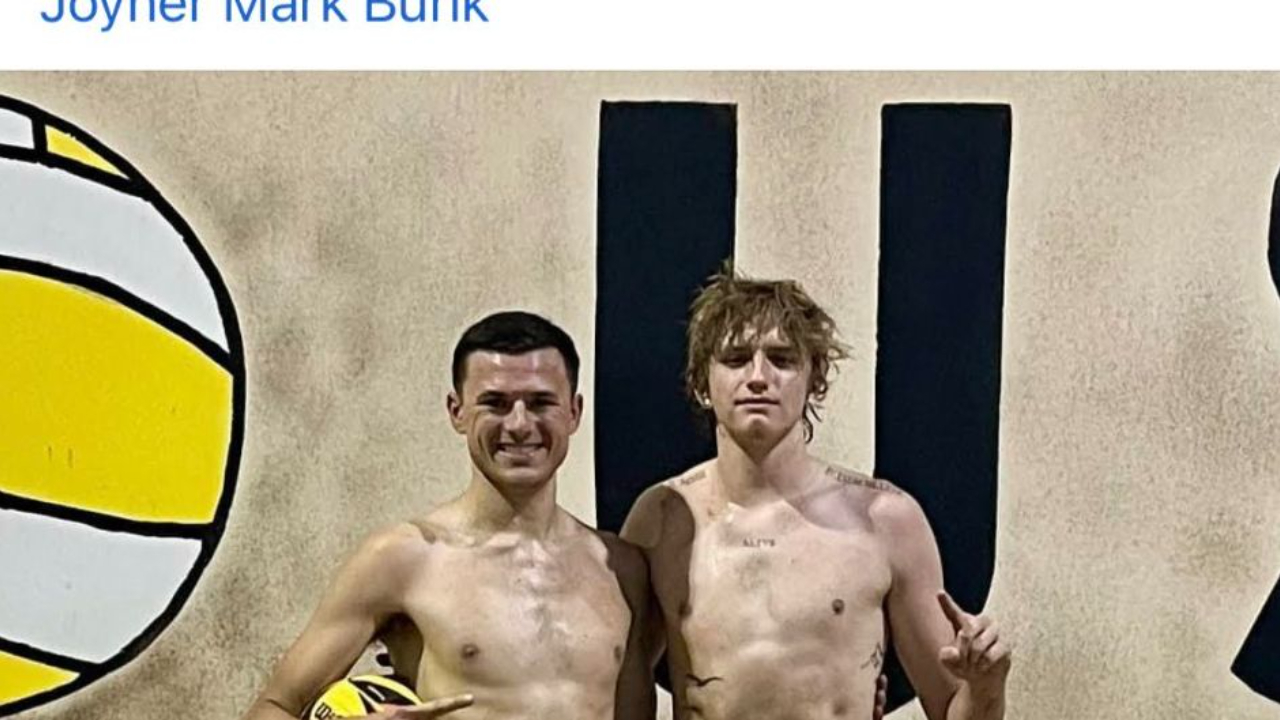 Two junior beach volleyball players celebrating a tournament win