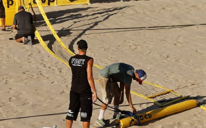 Three people setting up a net