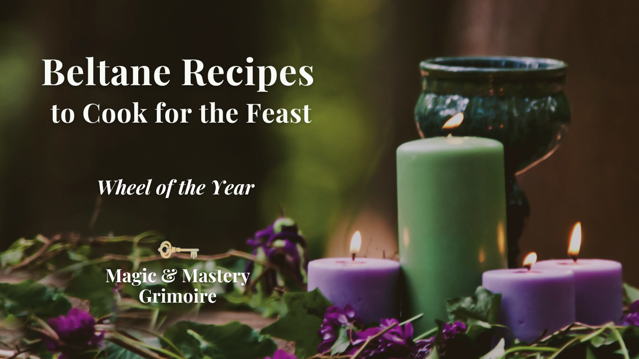 Pillar candles and purple flowers arranged on a bed of ivy leaves for Beltane