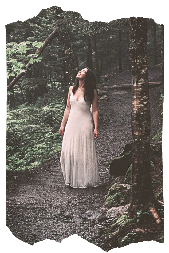 oman in white dress standing on a forest path gazing upward — the Seeker archetype for beginners starting their magical journey in Way of the Mage