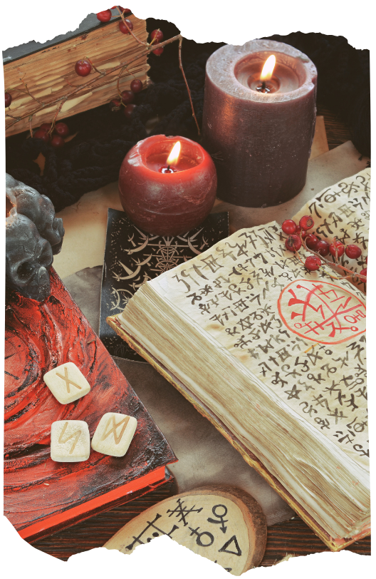 Rune stones, a lit candle, and an open book of symbols on a table